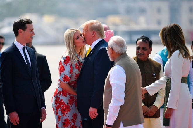 President Donald Trump kisses Ivanka Trump as India ' s Prime Minister Narendra Modi looks on upon their arrival in Ahmedabad on Feb. 24, 2020.