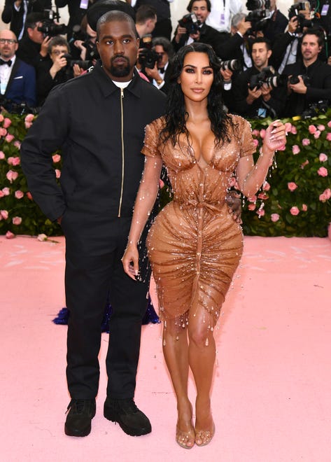 Who could forget Kardashian ' s Thierry Mugler look at the 2019 Met Gala, that came with a corset so tight she had to take lessons to breathe in it ? West accompanied her in a darker, and seemingly more comfortable, outfit.